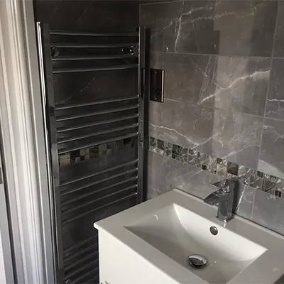grey shower with wall mounted radiator